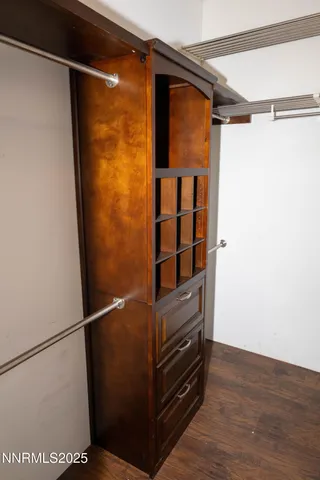 a view of walk in closet with empty racks