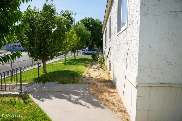 a view of a pathway of a house with a yard