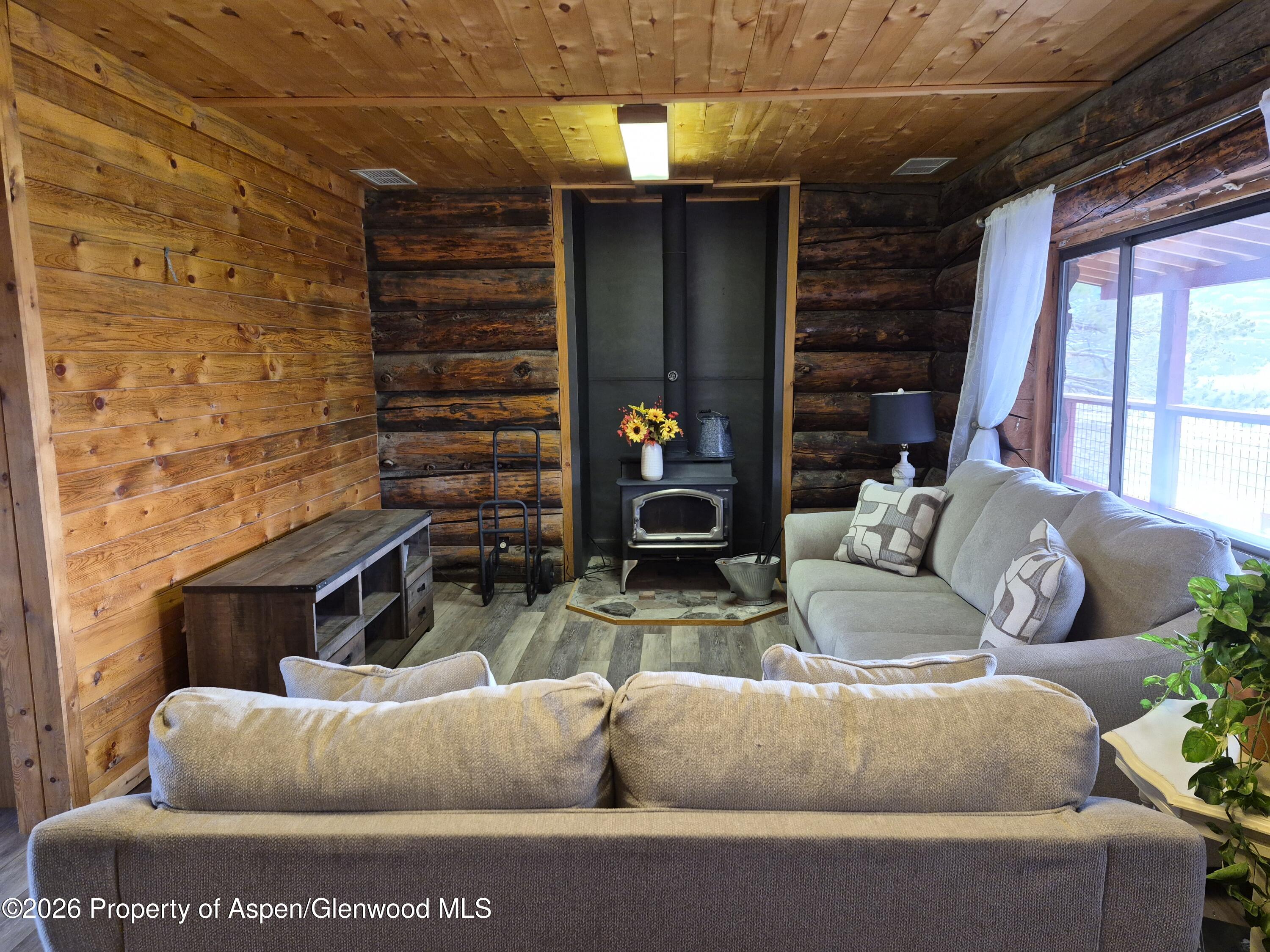 6194 County Road 320 Rifle, CO 81650 - Photo 22 of 54 a living room with furniture and a fireplace