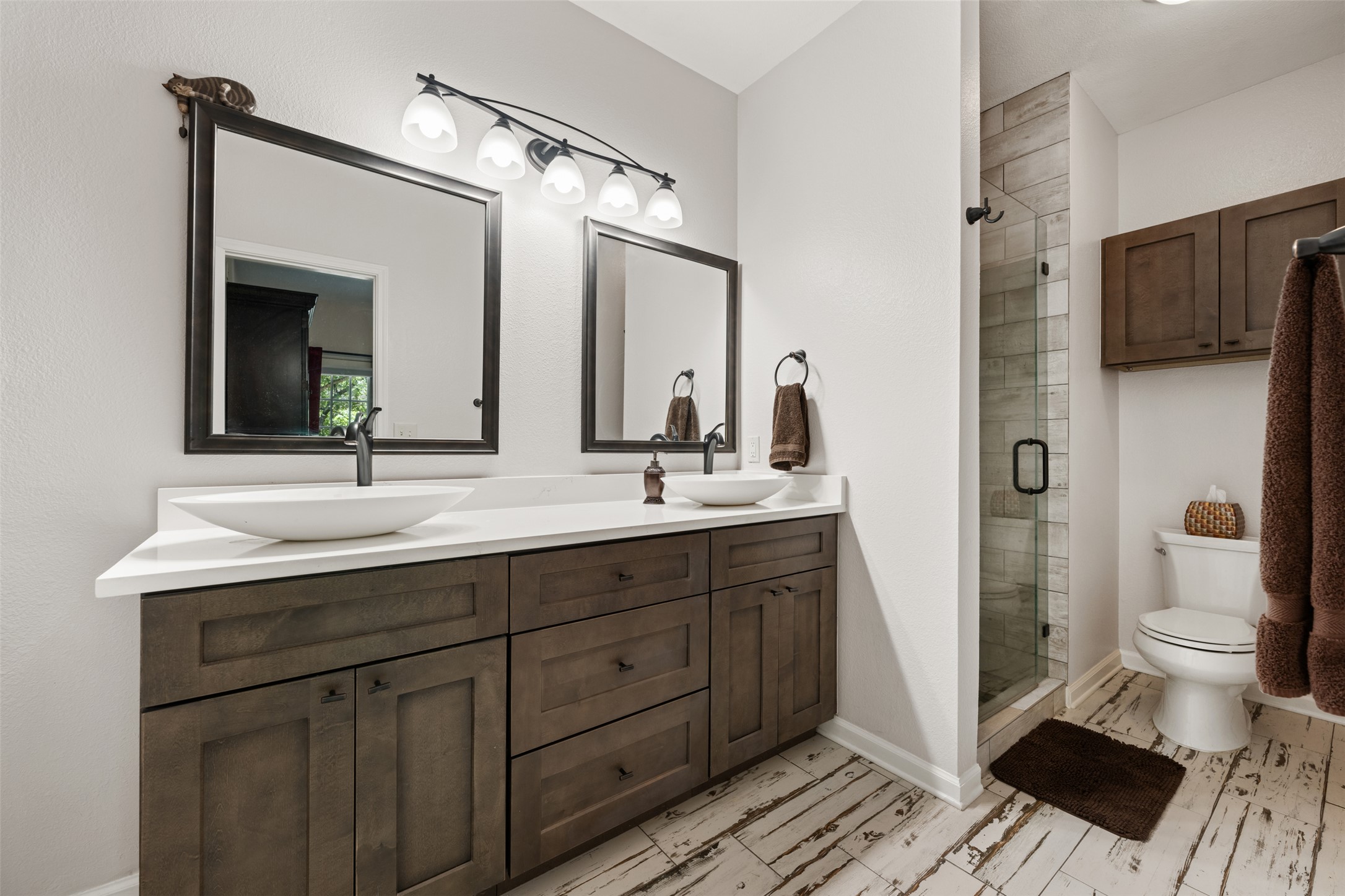11203 Ranch Road 2222, Unit 1407 Austin, TX 78732 - Photo 12 of 40 Raised bowl sinks and tastefully selected finishes elevate the ensuite bath.