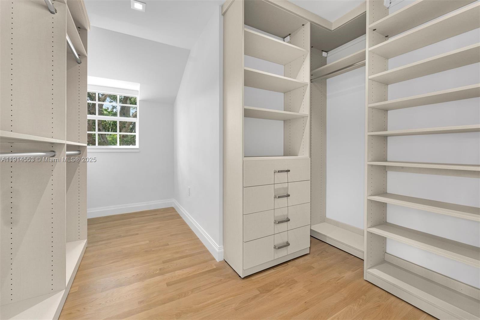 6675 Roxbury Lane Miami Beach, FL 33141 - Photo 11 of 40 a view of walk in closet with empty racks