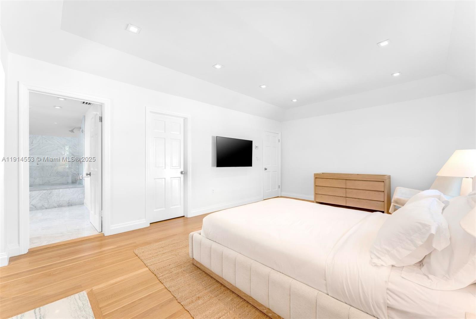 6675 Roxbury Lane Miami Beach, FL 33141 - Photo 17 of 40 a bedroom with a bed and a flat screen tv