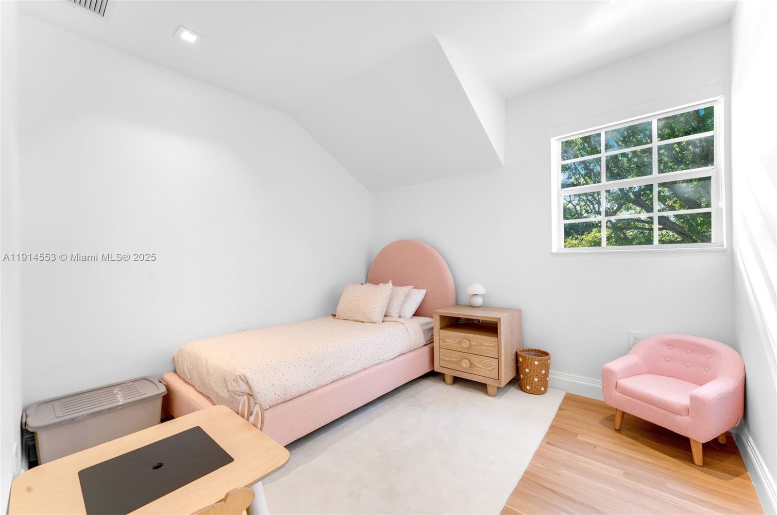 6675 Roxbury Lane Miami Beach, FL 33141 - Photo 18 of 40 a bedroom with a bed and a couch