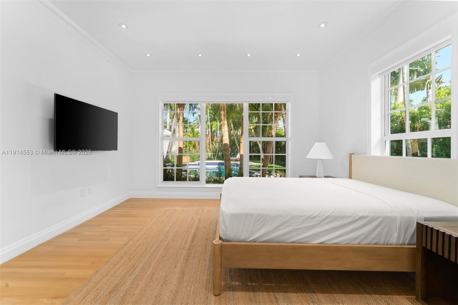 6675 Roxbury Lane Miami Beach, FL 33141 - Photo 25 of 40 a bedroom with a bed and a flat tv screen on dresser