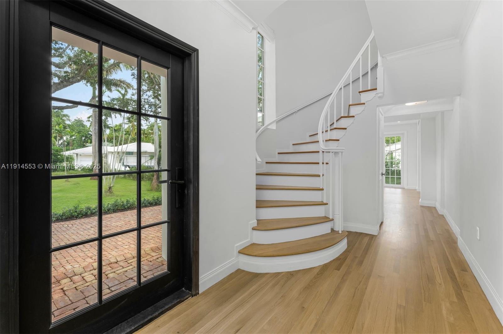 6675 Roxbury Lane Miami Beach, FL 33141 - Photo 3 of 40 a view of entryway with wooden floor and front door