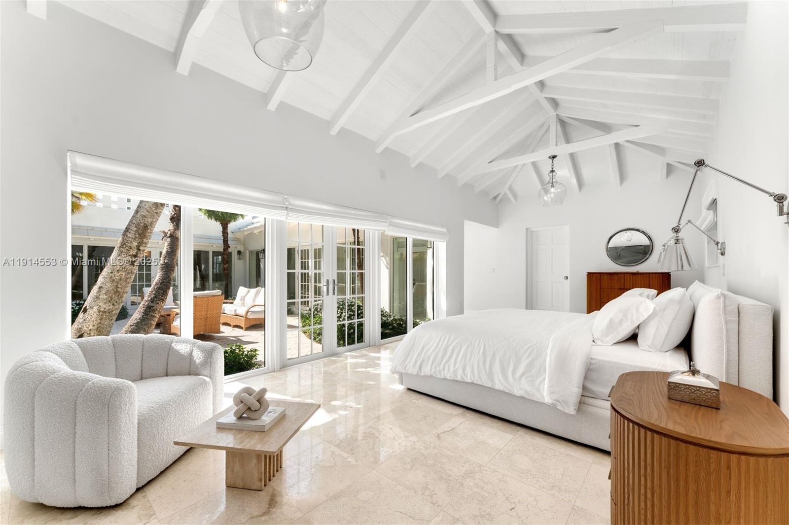 6675 Roxbury Lane Miami Beach, FL 33141 - Photo 31 of 40 a bedroom with a bed and a large window