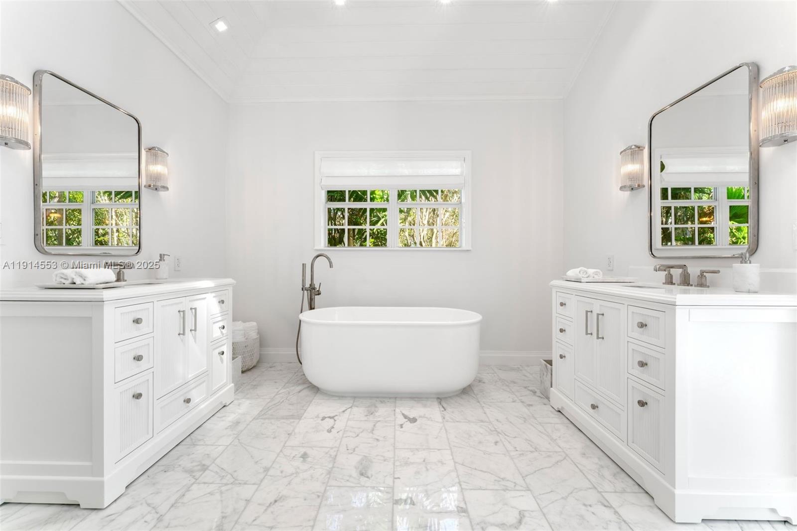 6675 Roxbury Lane Miami Beach, FL 33141 - Photo 37 of 40 a bathroom with a sink toilet a mirror and bathtub