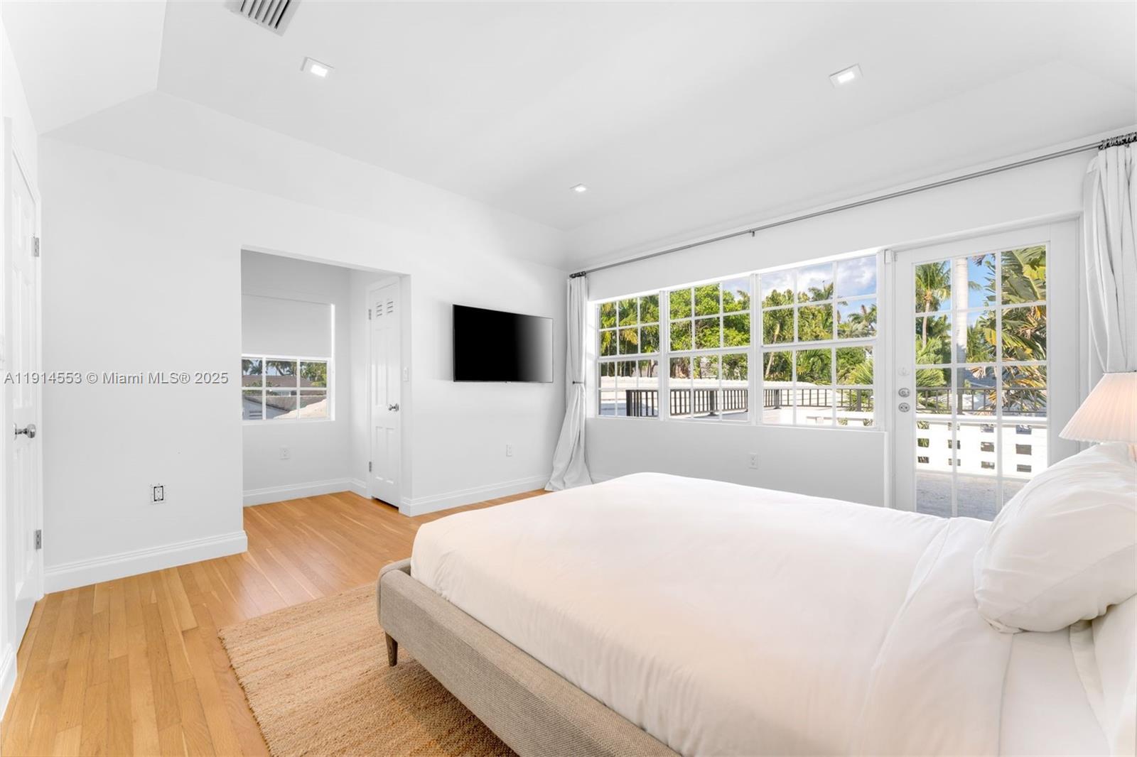 6675 Roxbury Lane Miami Beach, FL 33141 - Photo 40 of 40 a bedroom with a large bed and a large window