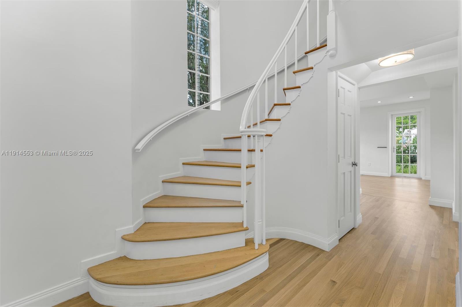 6675 Roxbury Lane Miami Beach, FL 33141 - Photo 4 of 40 a view of entryway with wooden floor and stairs