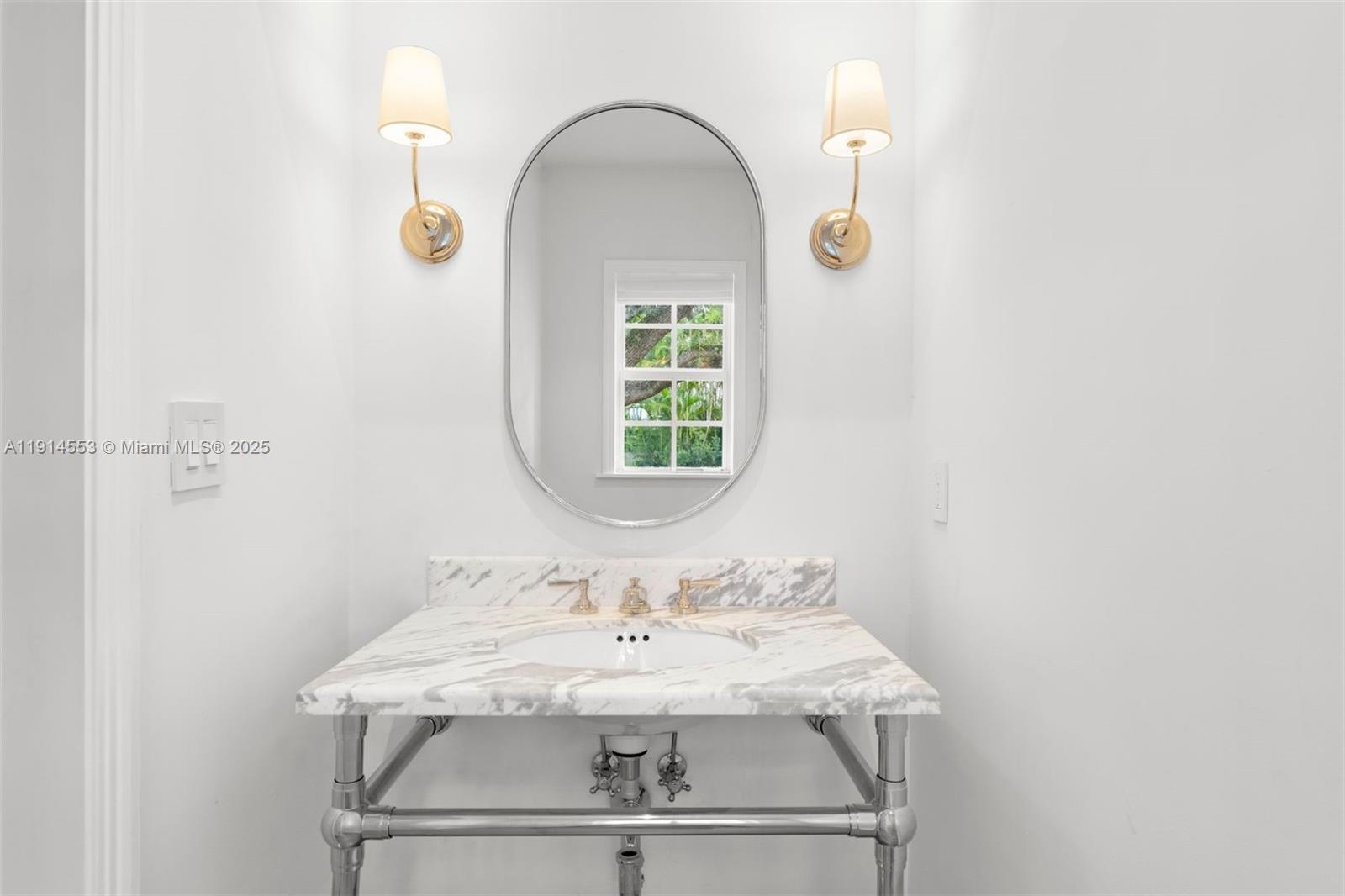 6675 Roxbury Lane Miami Beach, FL 33141 - Photo 7 of 40 a bathroom with a sink and a mirror