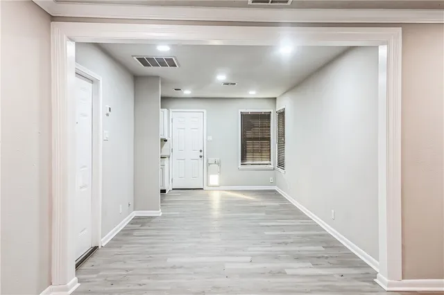a view of a hallway with wooden floor