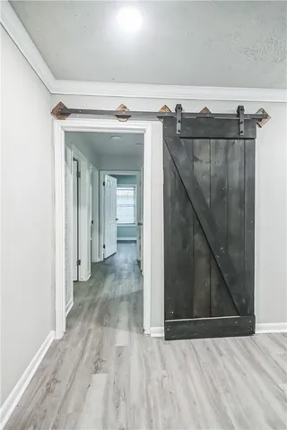 a view of a hallway with wooden floor and entryway