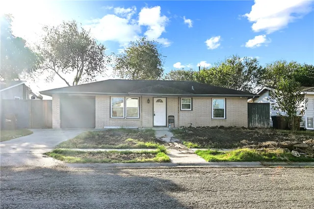a view of a house with a yard and sitting area