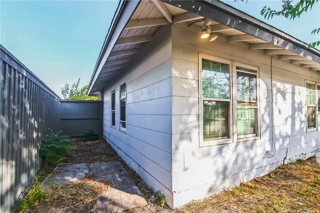 a view of small house with wooden fence