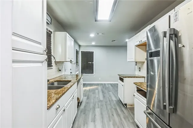 a kitchen with stainless steel appliances a refrigerator and a stove