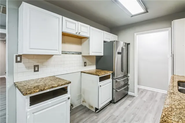 a kitchen with a stove a sink and a refrigerator