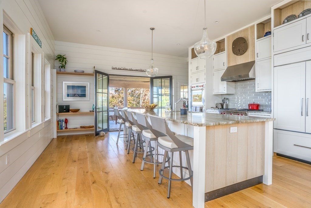 1526 Hyannis-Barnstable Road Barnstable, MA 02630 - Photo 5 of 7 a kitchen with stainless steel appliances granite countertop a stove a sink dishwasher and white cabinets with wooden floor