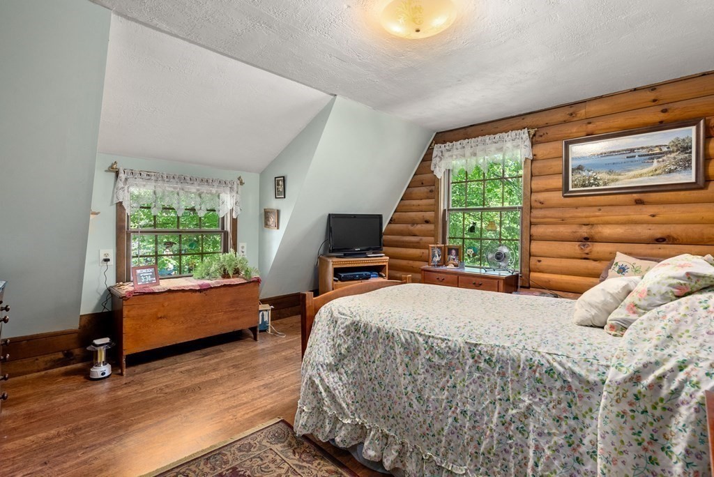 73 Allen Road Brookfield, MA 01506 - Photo 31 of 39 a bedroom with a bed and wooden floor