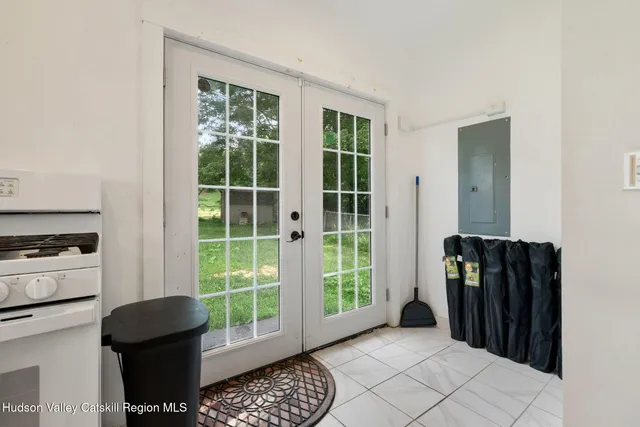a kitchen with white cabinets and white appliances