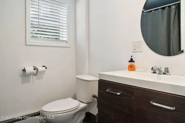 a white toilet sitting next to a bathroom sink