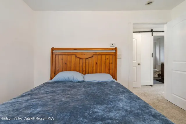 a view of a hallway with closet and front door