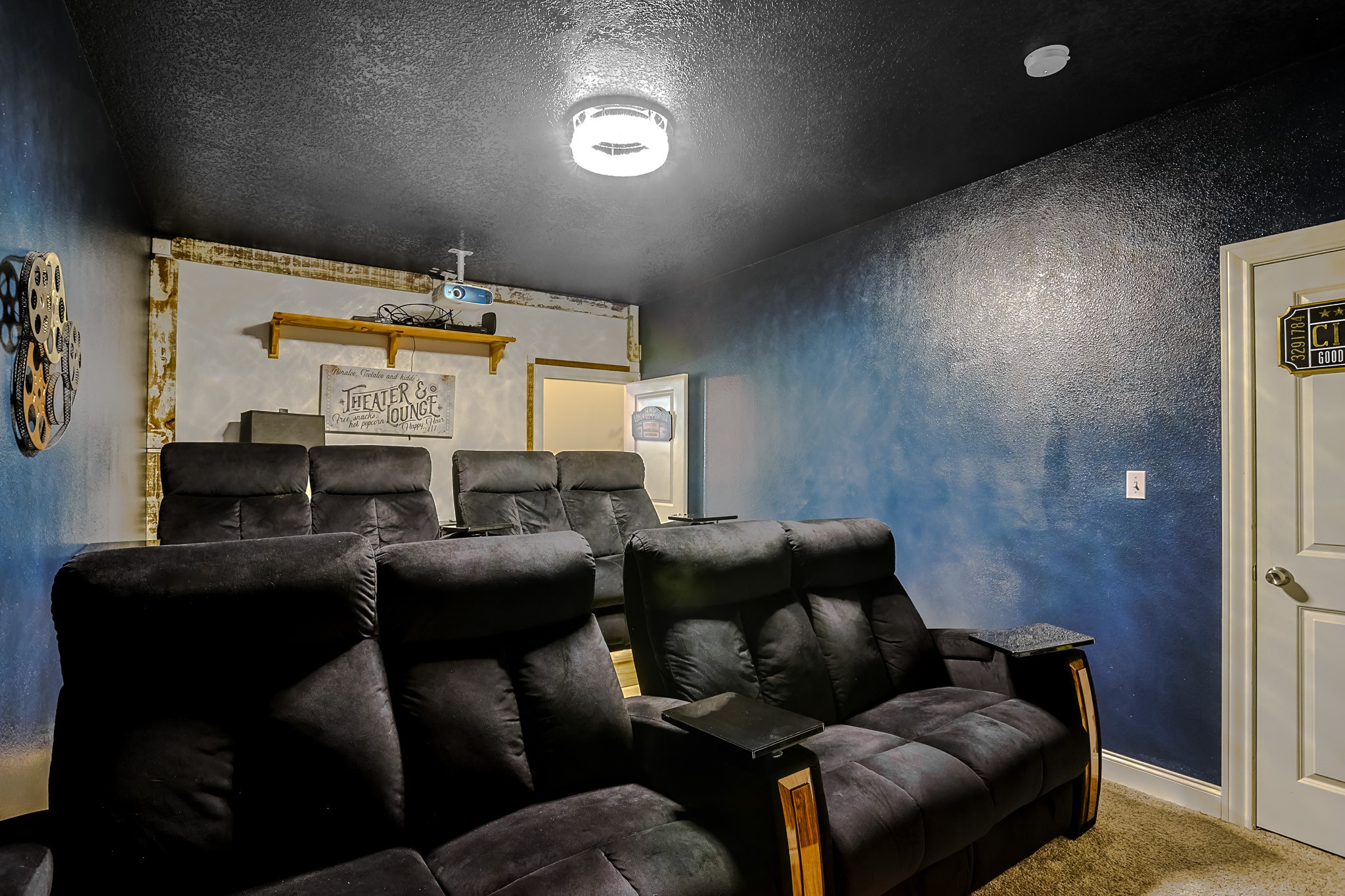 30119 West Geneva Drive Spring, TX 77386 - Photo 24 of 35 Cozy theater lounge featuring reclining chairs, projector setup, and moody lighting for movie nights in style