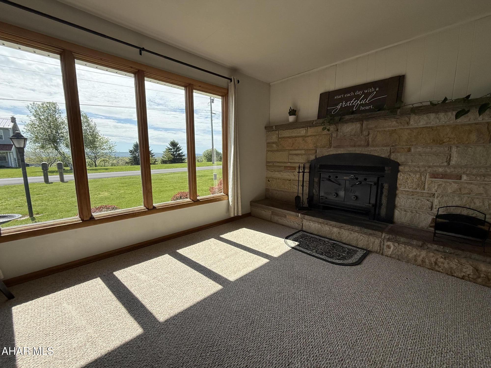 473 Calhoun Road Everett, PA 15537 - Photo 9 of 45 a living room with furniture and a fireplace