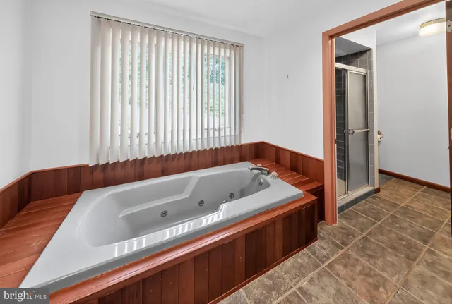a bathroom with a bathtub and a shower