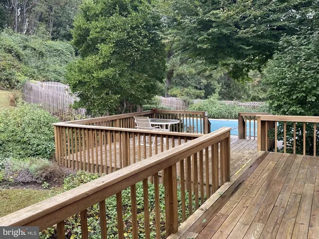 a view of balcony with wooden floor and fence