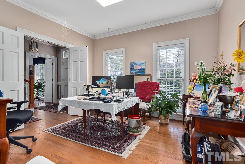 2416 Basil Drive Raleigh, NC 27612 - Photo 14 of 26 a living room with furniture potted plant and a window