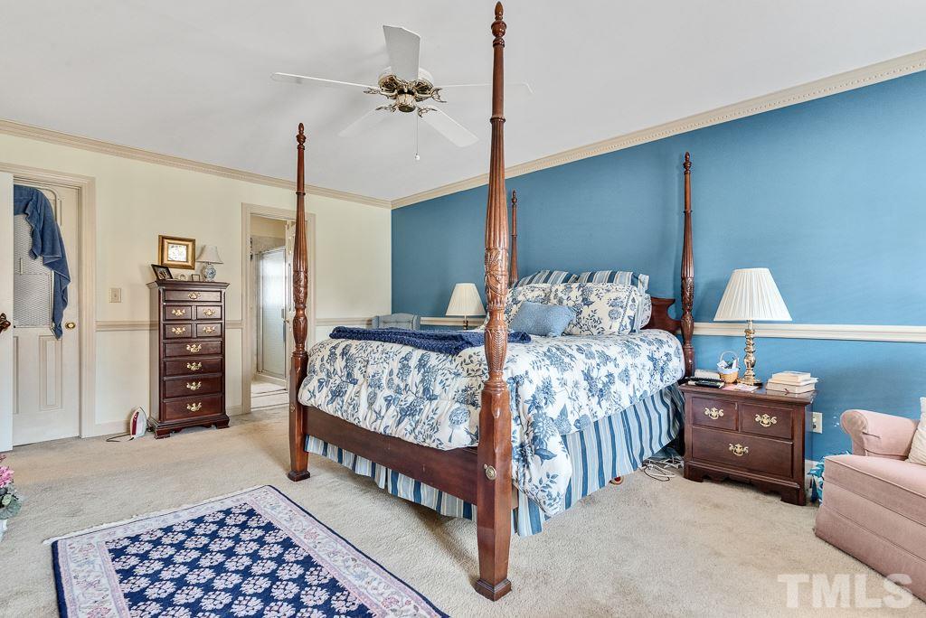 2416 Basil Drive Raleigh, NC 27612 - Photo 17 of 26 a bedroom with bed and a lamp