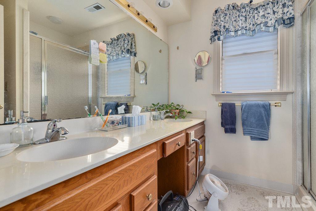 2416 Basil Drive Raleigh, NC 27612 - Photo 18 of 26 a bathroom with a sink and a mirror