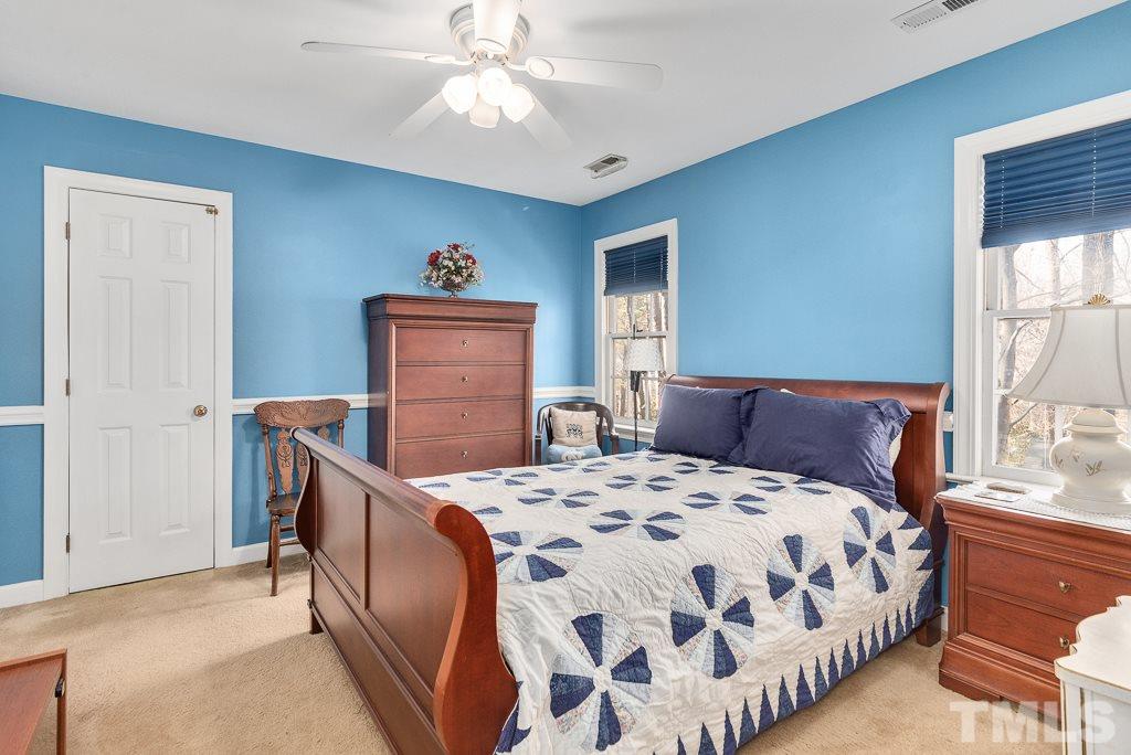 2416 Basil Drive Raleigh, NC 27612 - Photo 19 of 26 a bed sitting in a bedroom next to a window