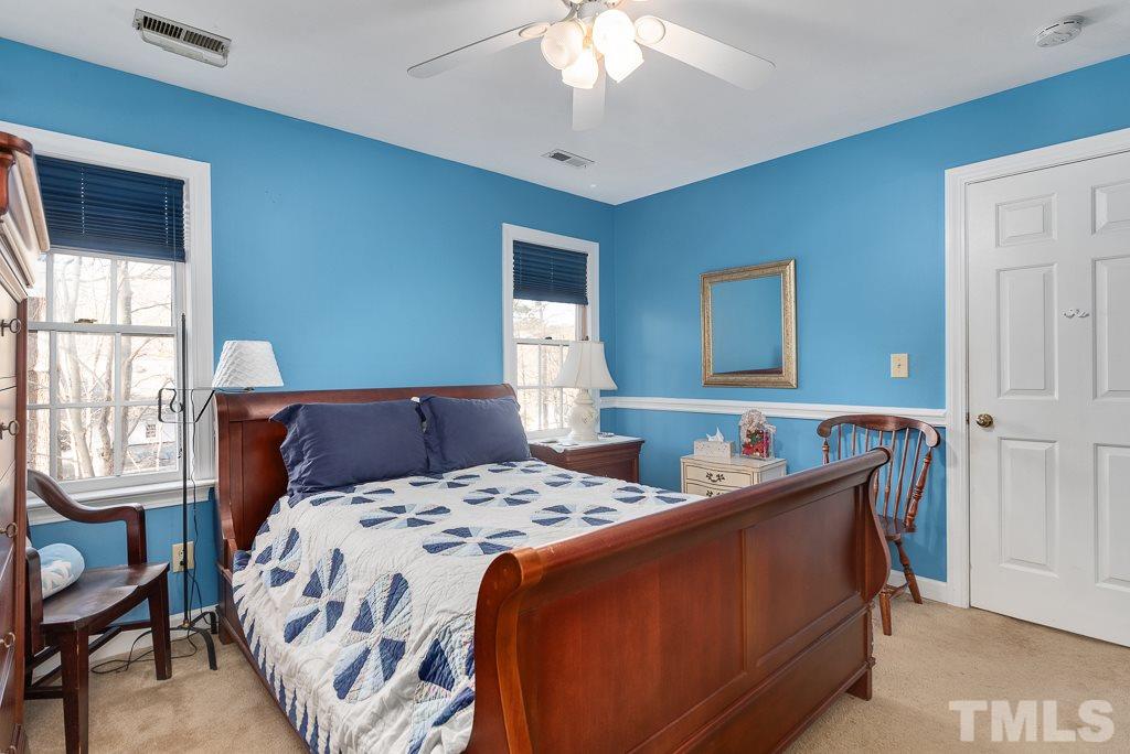 2416 Basil Drive Raleigh, NC 27612 - Photo 20 of 26 a bedroom with a bed and a window
