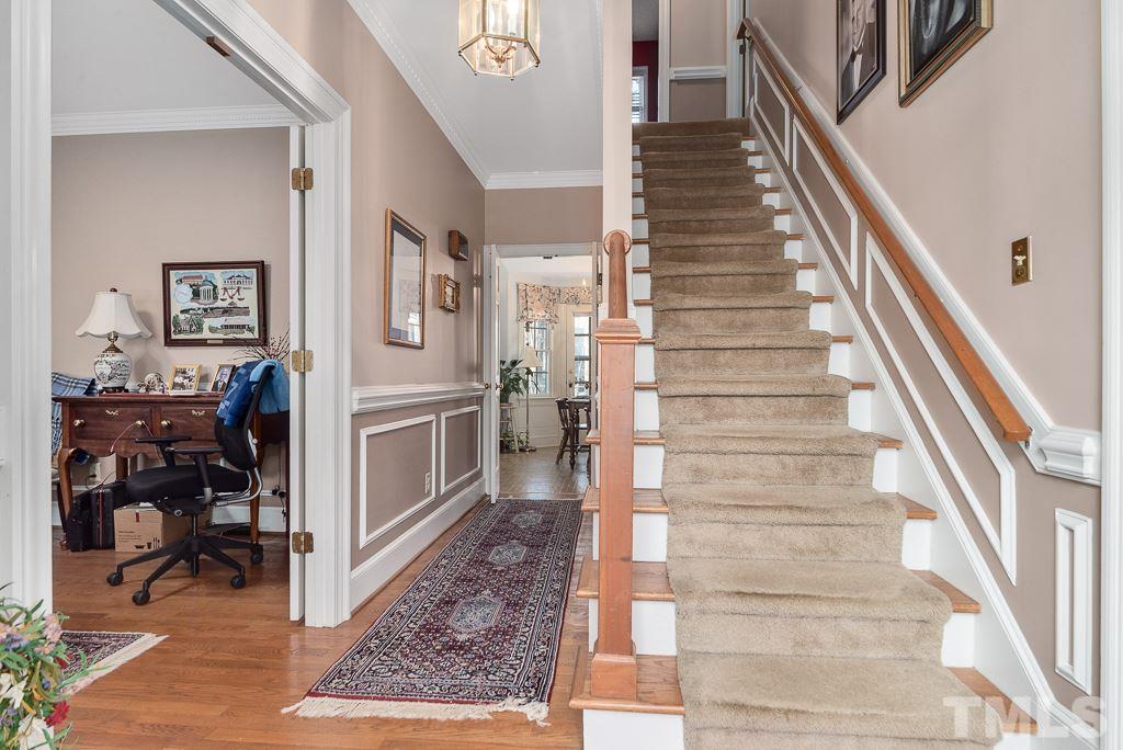 2416 Basil Drive Raleigh, NC 27612 - Photo 5 of 26 a view of staircase with lots of frames on wall and windows