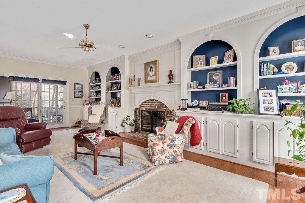 2416 Basil Drive Raleigh, NC 27612 - Photo 7 of 26 a living room with patio furniture and a fireplace
