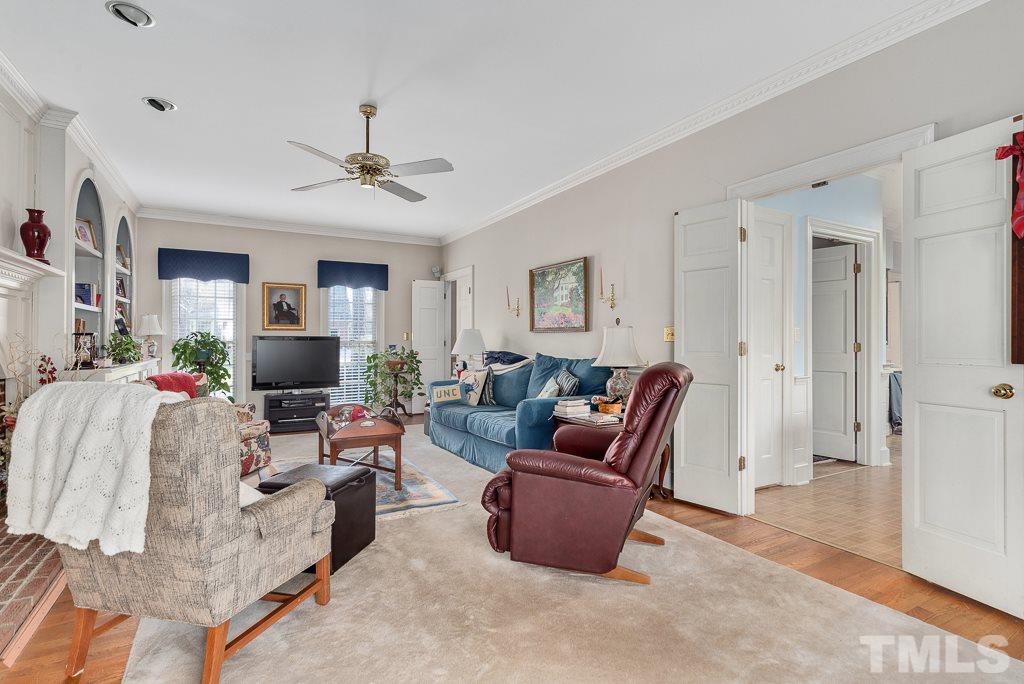 2416 Basil Drive Raleigh, NC 27612 - Photo 8 of 26 a living room with furniture a ceiling fan and a rug