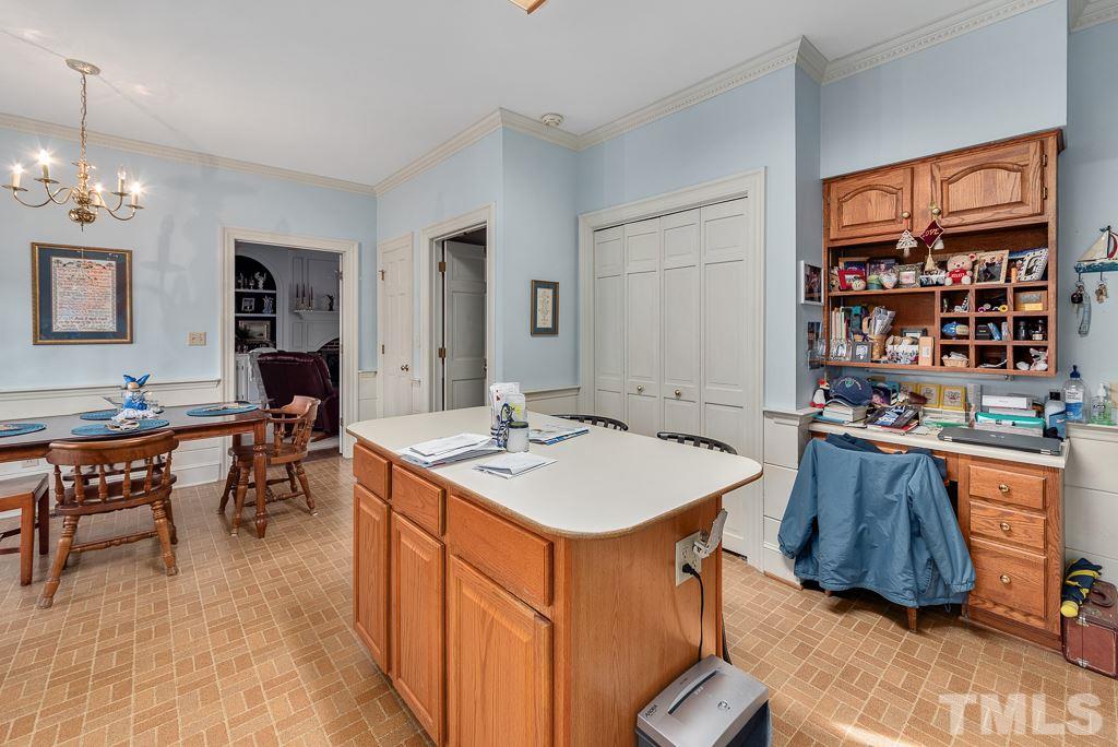 2416 Basil Drive Raleigh, NC 27612 - Photo 10 of 26 a living room with stainless steel appliances kitchen island granite countertop furniture and a dining table