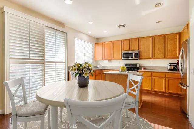 a kitchen with a table chairs sink and cabinets