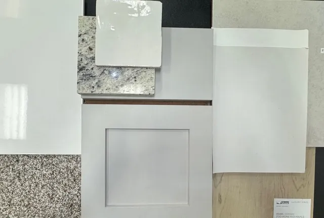 a view of a house with a small yard plants and large tree