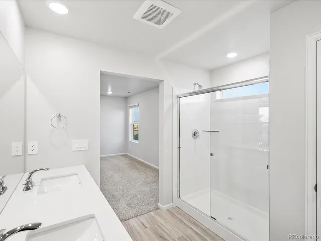 a bathroom with double vanity sinks and a mirror