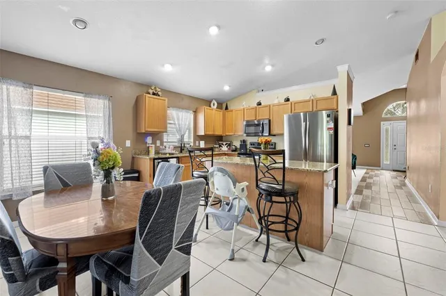 a living room with furniture a fireplace and a large window