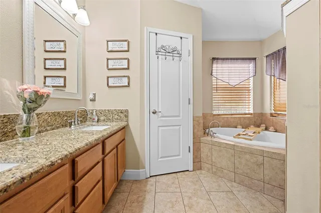 a bath tub sitting in a bathroom next to a window
