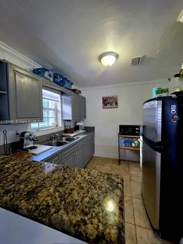 a kitchen with refrigerator and stove