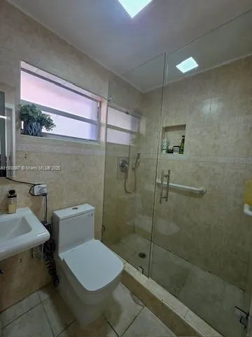 a bedroom with a bed and flat screen tv