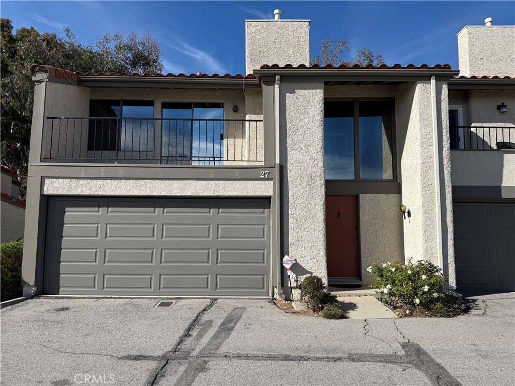 19547 Rinaldi Street, Unit 27 Porter Ranch, CA 91326 - Photo 1 of 20 a front view of a house with a yard