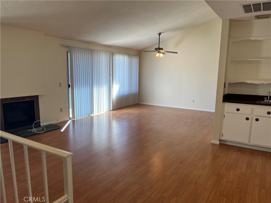 19547 Rinaldi Street, Unit 27 Porter Ranch, CA 91326 - Photo 12 of 20 a view of an empty room with wooden floor and a cabinet