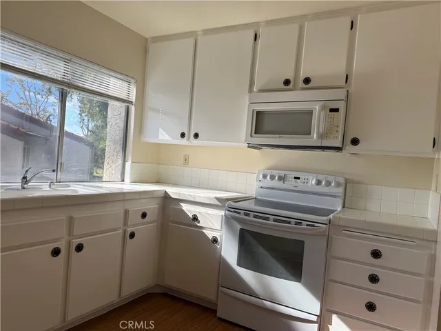 a view of a hallway with wooden floor and entryway