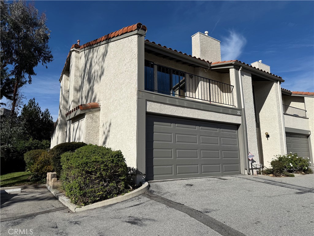 19547 Rinaldi Street, Unit 27 Porter Ranch, CA 91326 - Photo 2 of 20 a front view of a house