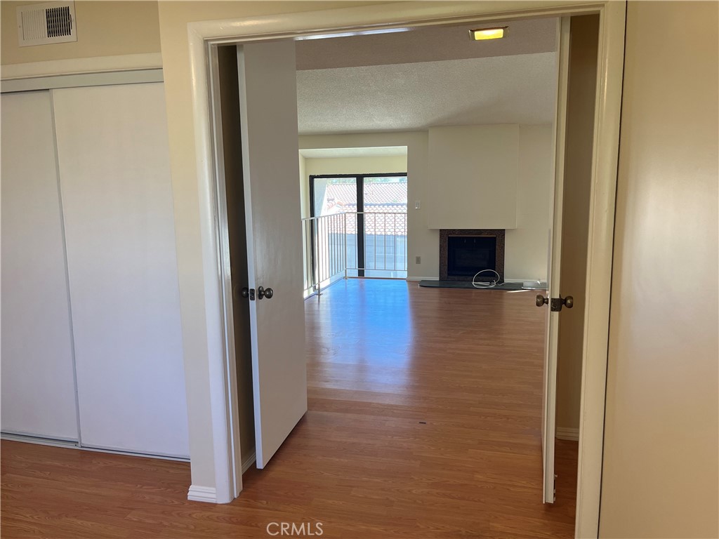 19547 Rinaldi Street, Unit 27 Porter Ranch, CA 91326 - Photo 9 of 20 a view of a hallway with wooden floor